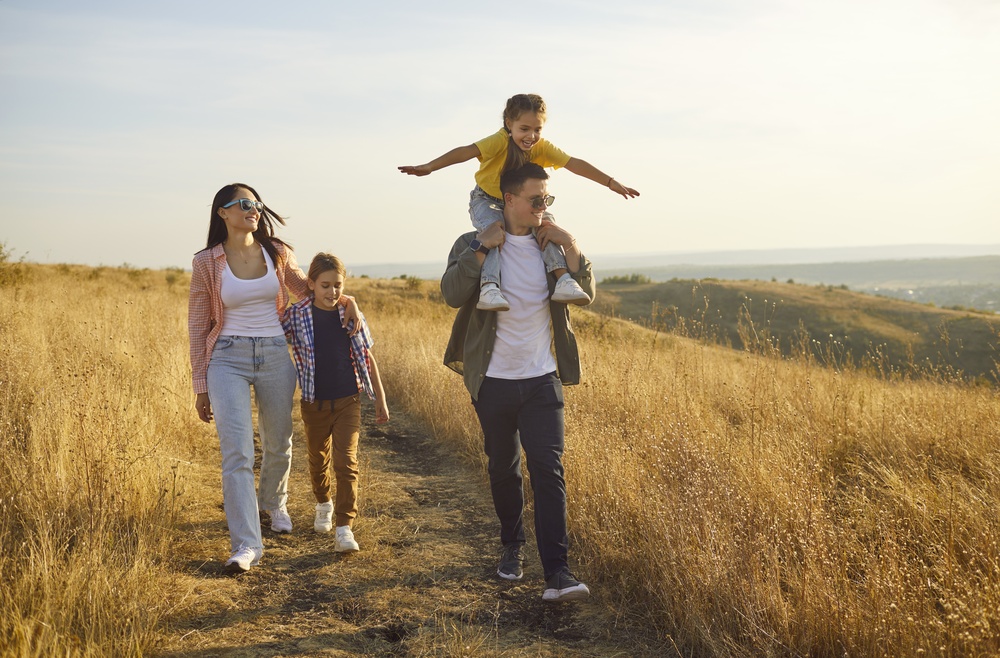 Happy young family walking in nature